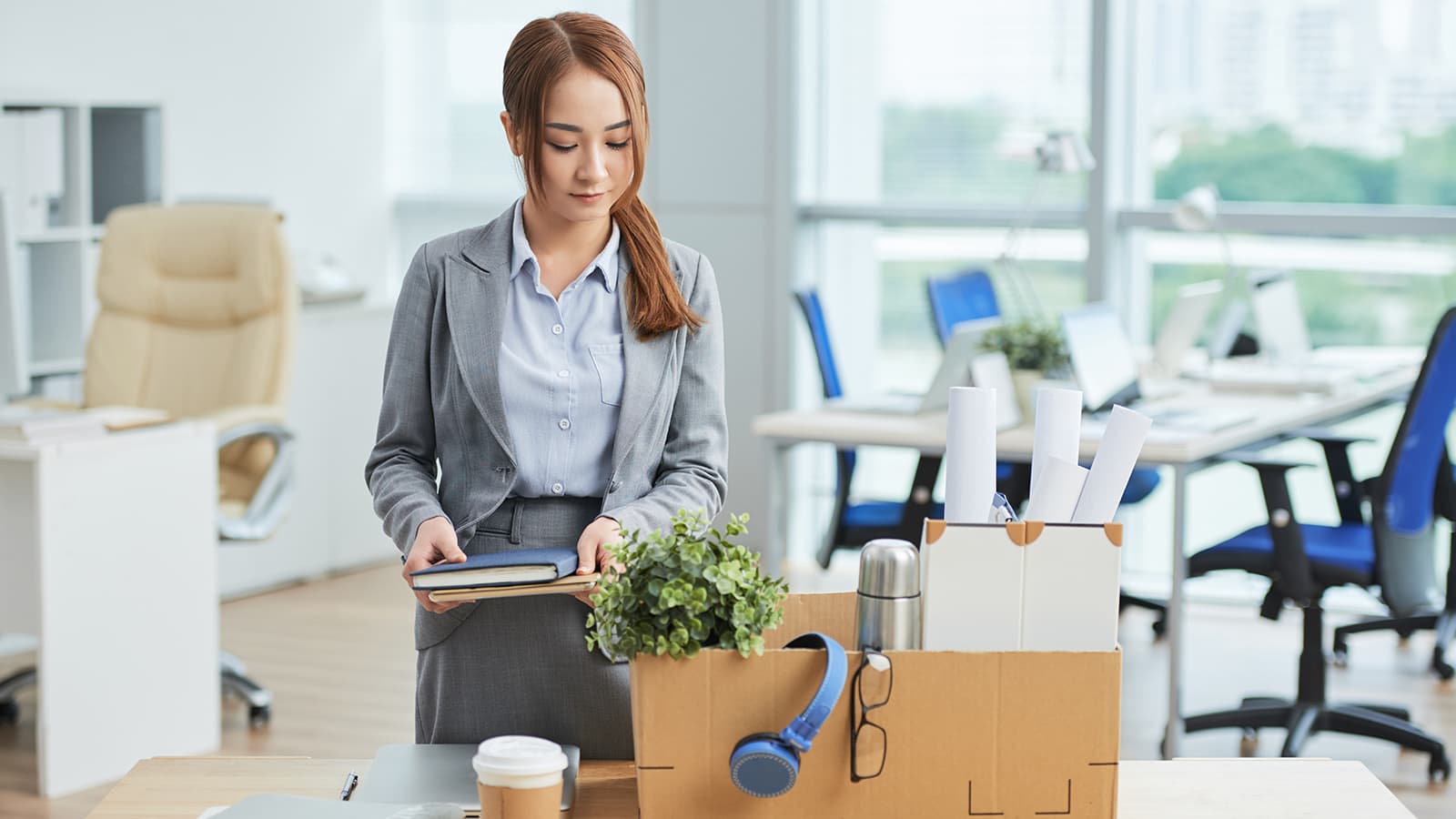 businesswoman packing up her desk