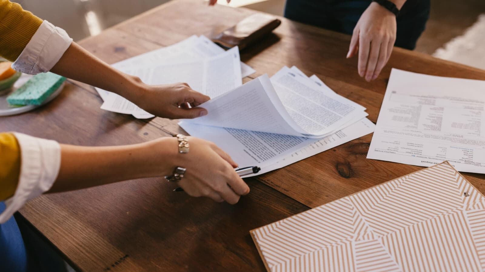 Woman holding a stack of papers
