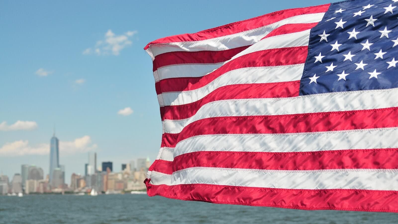 Veteran with backpack and flag