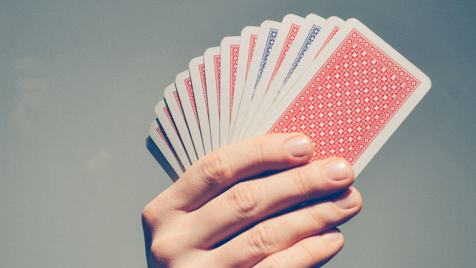 Hand holding a deck if cards