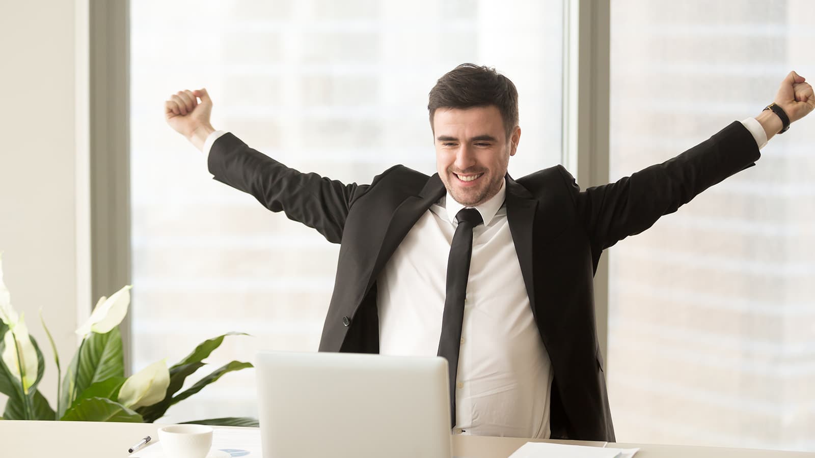 man stretching at his laptop