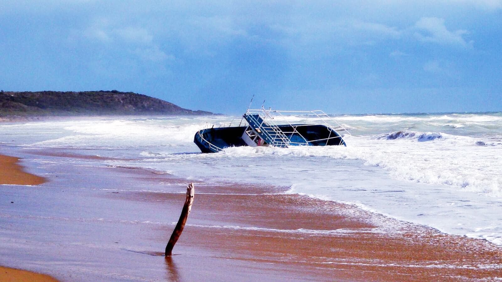 A boat tipping over in the water