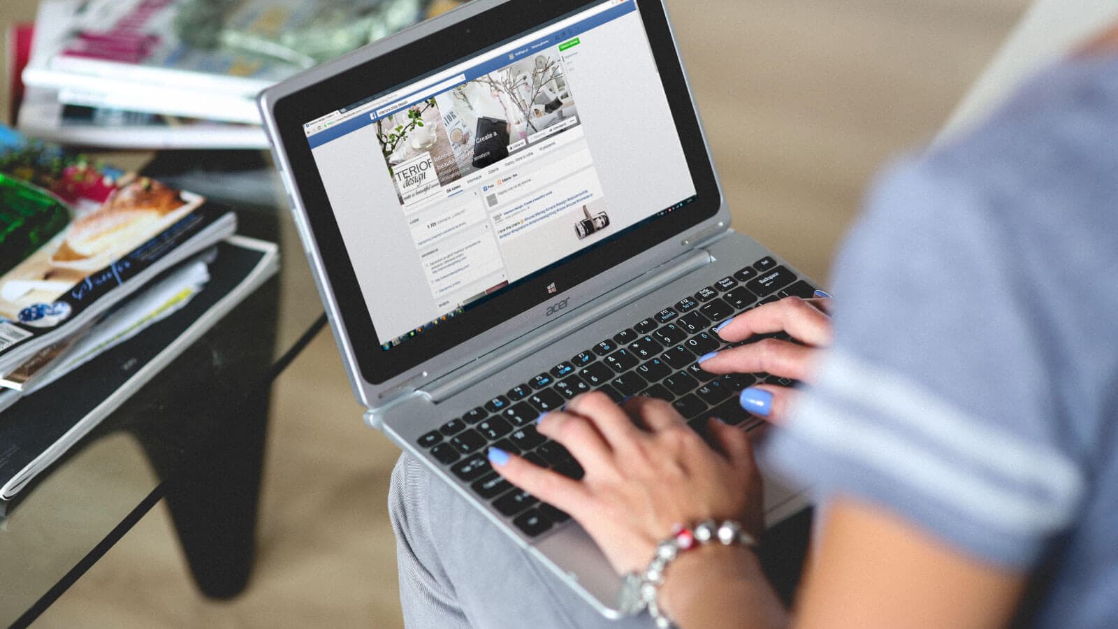 Someone typing with a computer on their lap