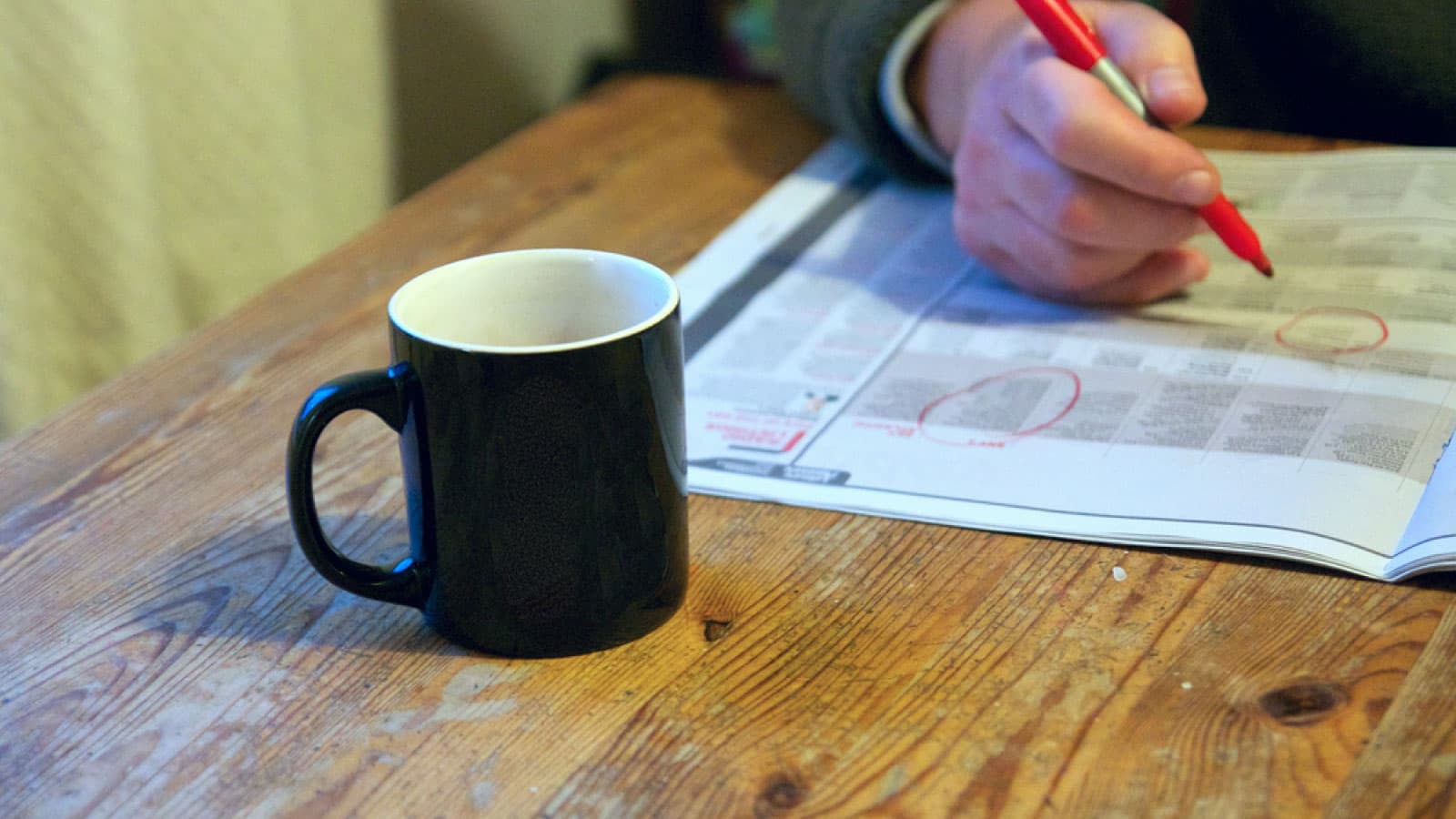 Coffee and job section of newspaper