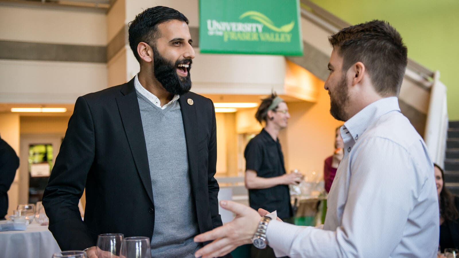 Two men speaking at a networking event