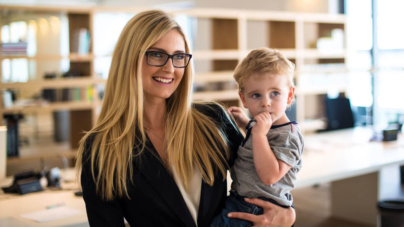 Mom holding son at an office
