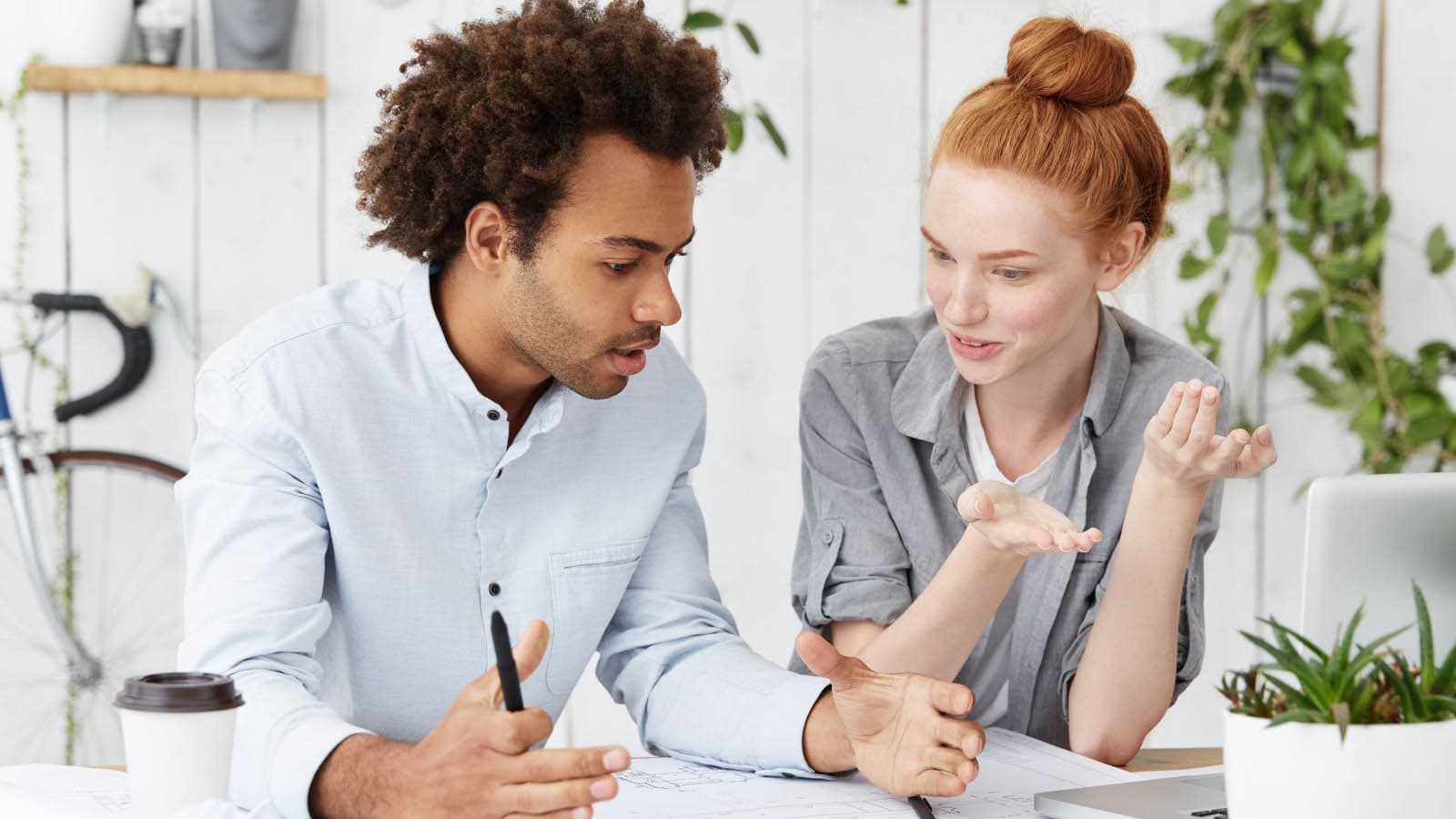 Man and woman chatting at desk