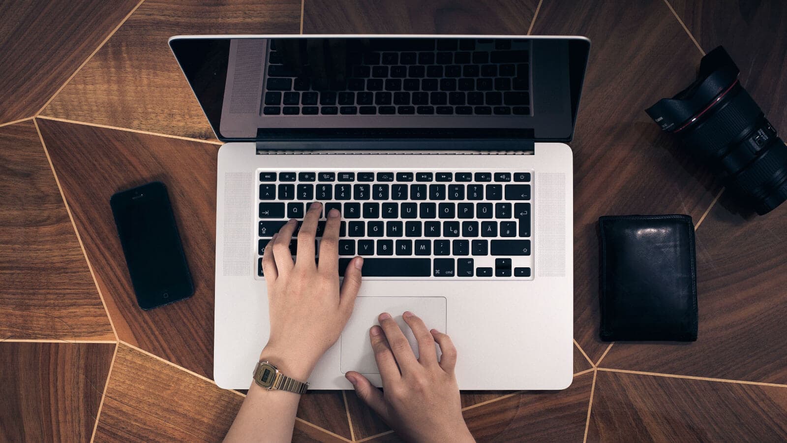Hands typing on laptop